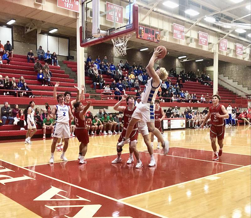 Princeton's Daniel Sousa beats the buzzer for a putback at the end of the first quarter in Friday's early tournament action against L-P at Ottawa. The Tigers rallied late for a 53-46 win.