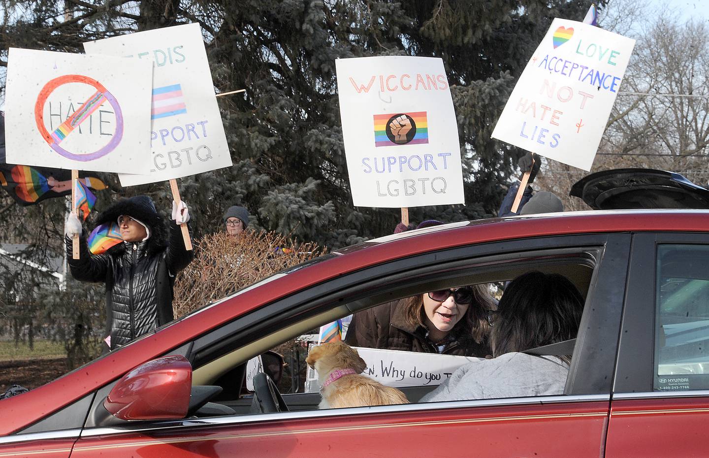 Martha McAdams, who says she is in support of love and inclusion, talks with a fellow supporter in front of the Sandwich Opera House on Saturday, Feb. 18, 2023.