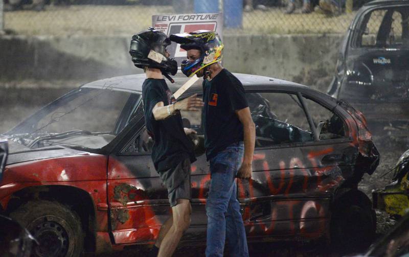 Levi and Buddy Fortune, both of Sterling, celebrate after finishing first and second in the Compact Heat at the Ogle County Fair's demolition derby on Saturday, Aug. 2, 2025.