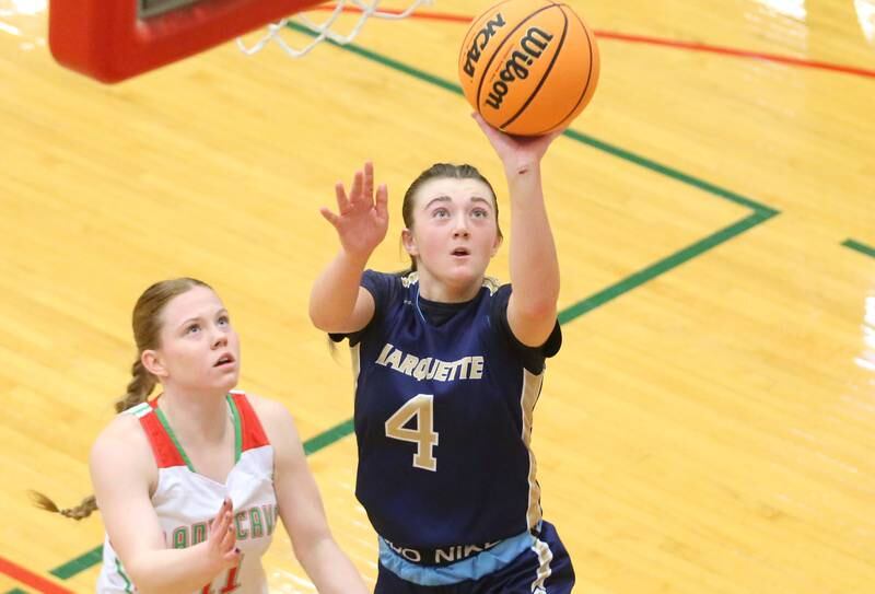 Marquette's Hunter Hopkins lets go of a shot underneath the hoop as L-P's Elizabeth Sines defends on Saturday, Jan. 4, 2025 in Sellett Gymnasium at L-P High School.