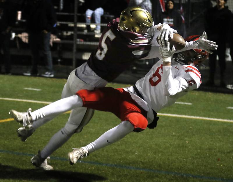 Huntley's Jacob Witt catches a touchdown pass as St. Ignatius' Danny Howard tries to break up the play during a IHSA Class 8A second round playoff football game on Friday, Nov. 3, 2023, at St. Ignatius College Prep in Chicago.