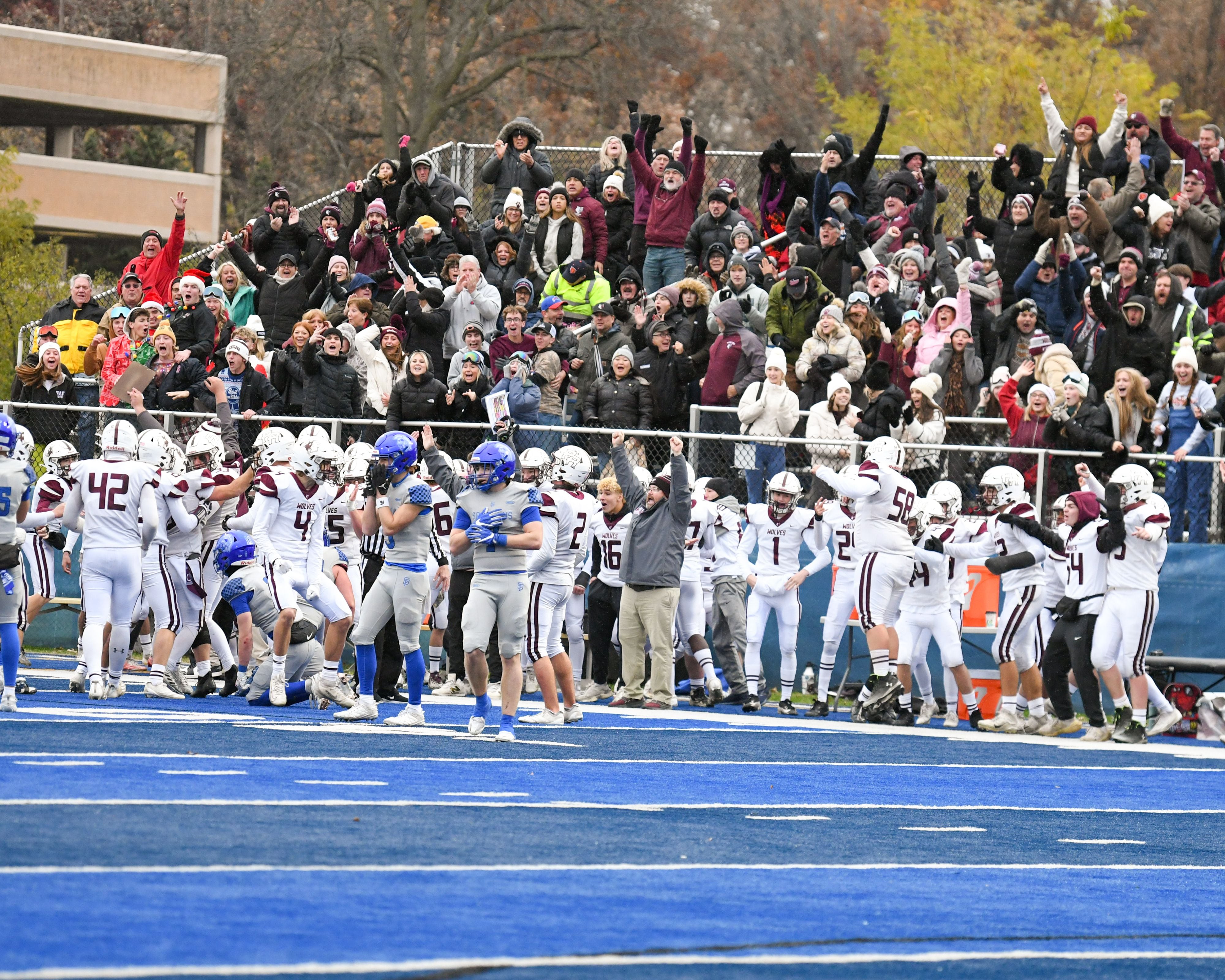 Prairie Ridge’s football team and fans celebrate after getting an onside kick during the second round of the 5A playoff game to take on St. Francis on Saturday Nov. 8, 2025, held at St. Francis's High School.