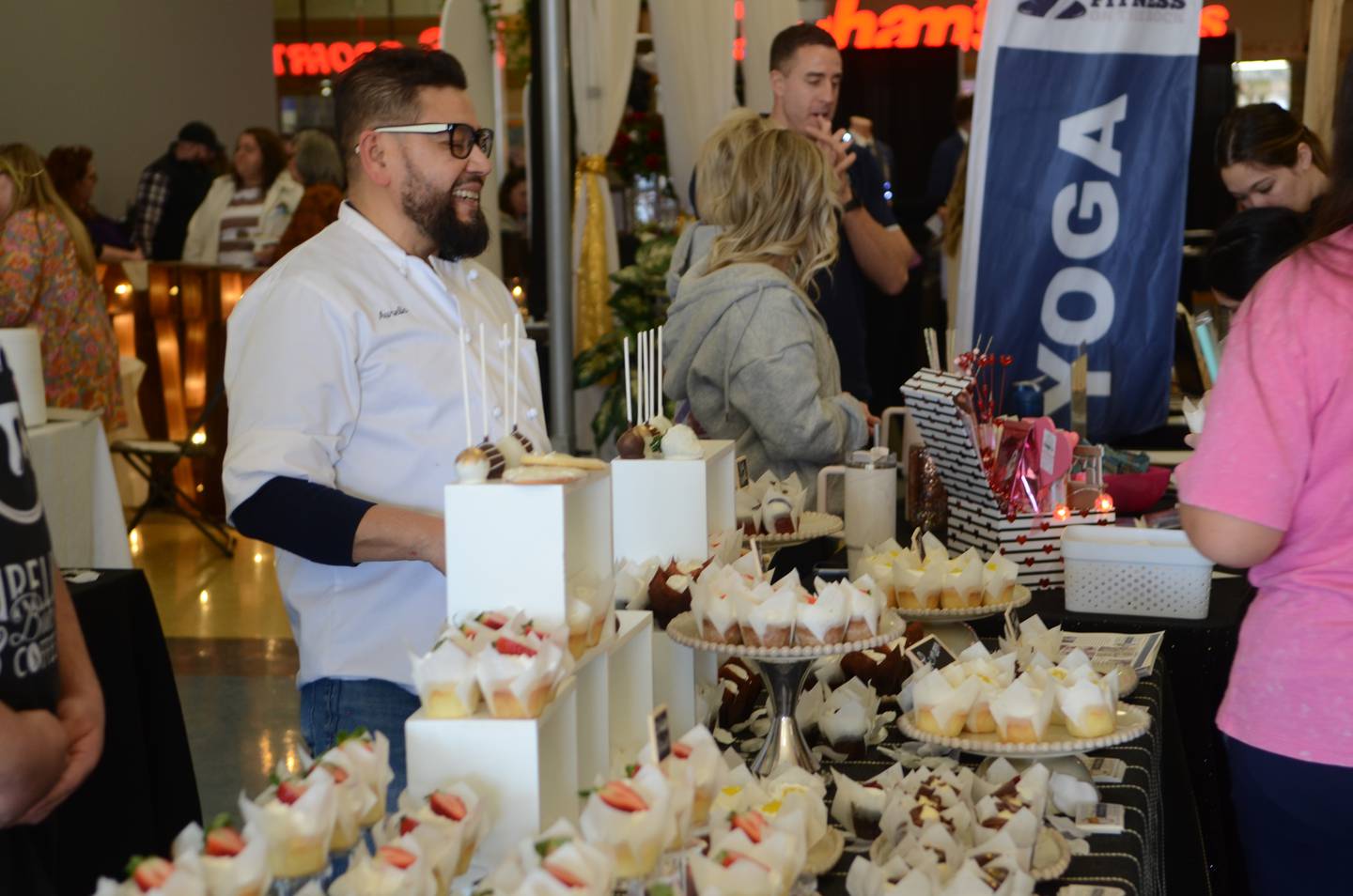 Aurelio Gallardo talks to Sauk Valley Wedding Expo guests on Sunday at Northland Mall, Sterling. Gallardo, owner of Aurelio's Bake Shop and Coffee House in Sterling, displayed a wide variety of cakes and cupcakes, which were available for sampling.