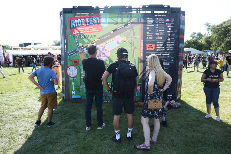 Festival goers check out the map on day one of Riot Fest, Friday, Sept. 15, in Chicago.