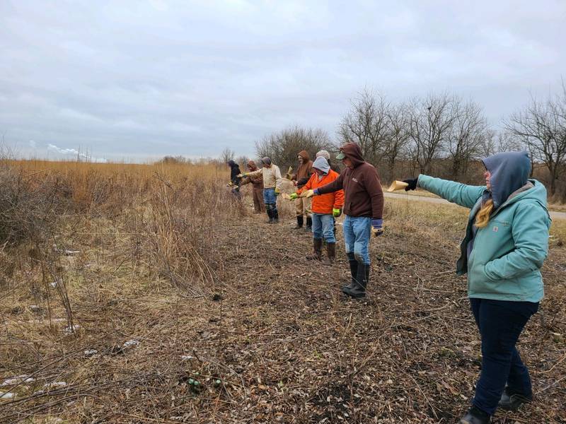 Forest service volunteers spread seeds of hope and renewal during a very special winter seed broadcast celebrating the new year at Midewin National Tallgrass Prairie. Pictured, from left: Midewin National Tallgrass Prairie botanist Michelle Pearion, Paul Schiesinger, Frederick Hodgers, Bill Mains, Mike Rzepka, Charles Stark, Sally Wieclaw and John Field.