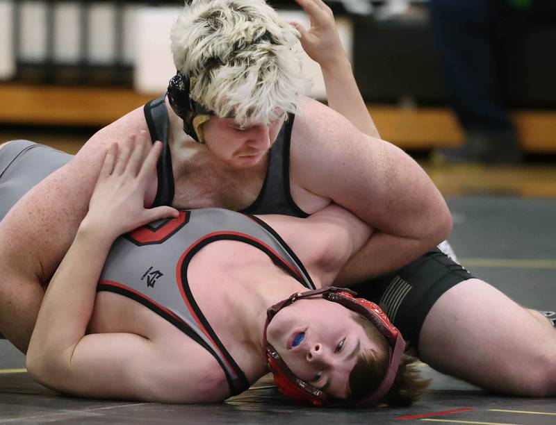 Sycamore’s Gable Carrick scores points against Ottawa’s Ryan Wilson during their 190 pound match Thursday, Dec. 14, 2023, at Sycamore High School.