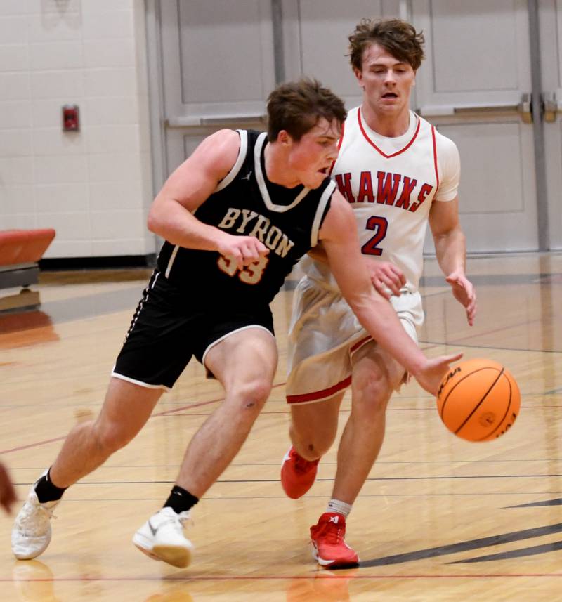 Byron's Caden Considine (33) reaches to take the ball away from Oregon's Cooper Johnson (2) on Monday, Dec. 15, 2025 game at the 64th Forreston Holiday Tournament at Forreston High School.