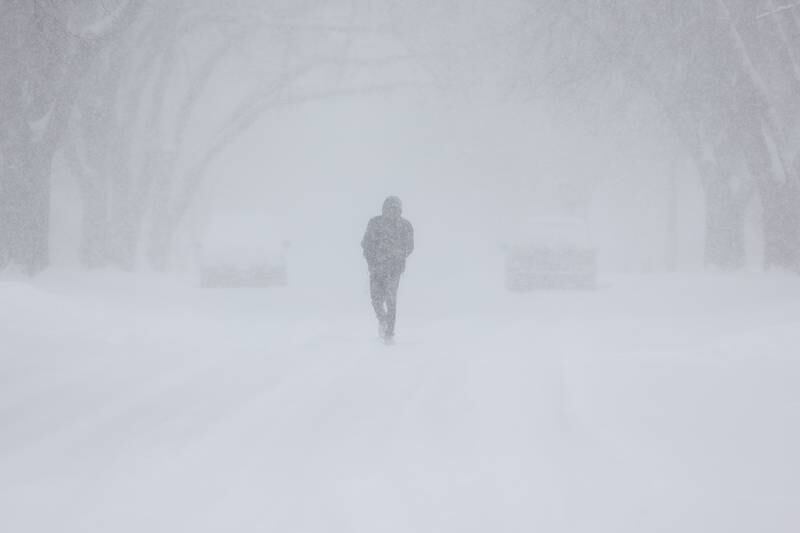 A pedestrian walks down the middle of Oneida Street as heavy snows continue to fall. Wednesday, Feb. 2, 2022 in Joliet.