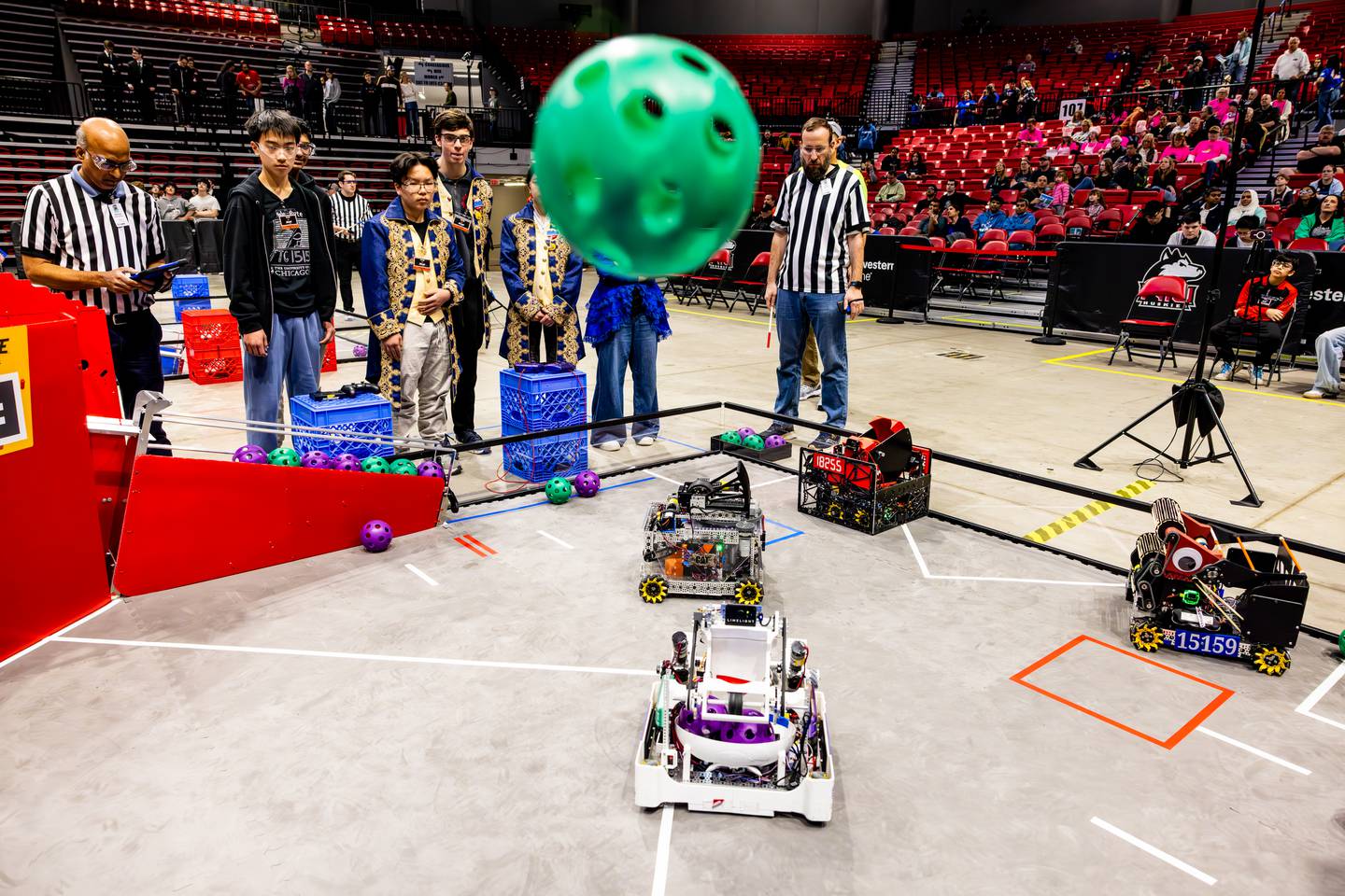 In early-round action, students see whether a foam “artifact” will land inside a basket at the FIRST Tech Challenge State Championship on March 7, 2026, in DeKalb. Points are tallied when doing so. Strategy includes avoiding defenders in a bid to outscore opponents.