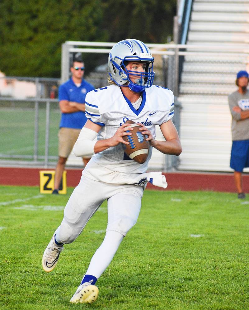 Woodstock's Jackson Lyons looks to pass against Rochelle in the Blue Streaks' season opener on Friday in Rochelle.