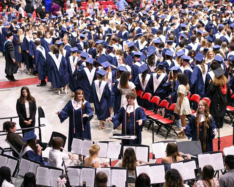 Oswego High School senior drum majors enjoy conducting one last song before leaving the graduation ceremony on Saturday May 17, 2025, held at the Convocation Center in DeKalb.