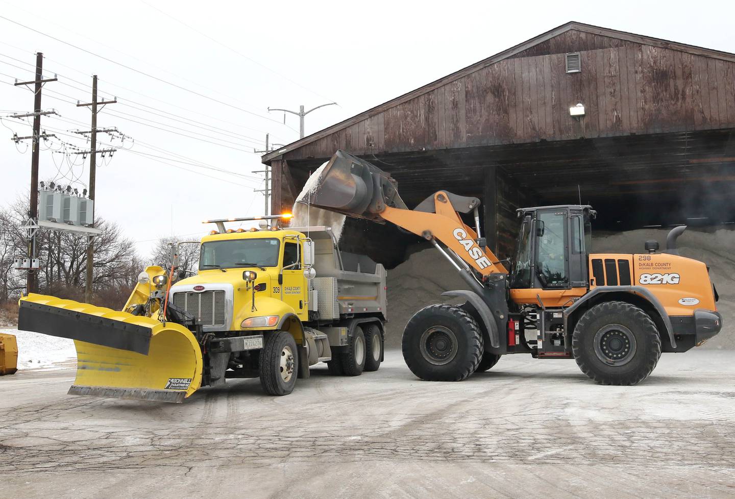 A loader pours salt into a snowplow Tuesday, Dec. 20, 2022, at the DeKalb County Highway Department location in DeKalb. A significant winter storm is expected Thursday and Friday that will blanket the area with several inches of snow.