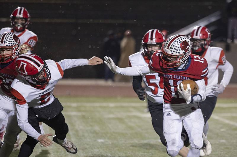 West Central’s Kaiden Droste looks to break a tackle Friday, Nov. 18, 2022 in the 8-man championship football game against Amboy.
