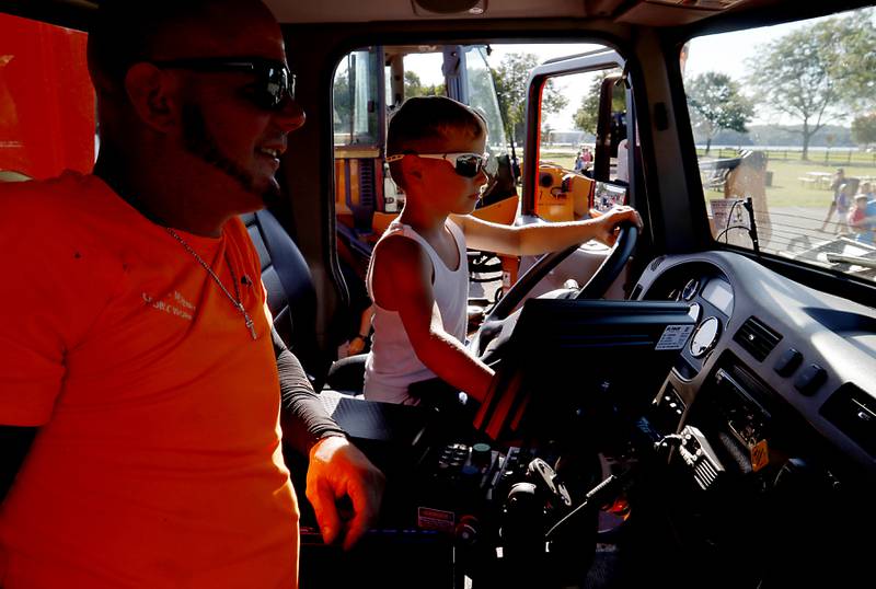 Daniel Gorski, 6, of McHenry, operates a McHenry Public Works snow plow under the watchful eye of Nate Banwart during National Night Out! Tuesday, August 9, 2022, at Petersen Park in McHenry. The event was put on by the McHenry County Sheriff’s Office, City of McHenry Police Department and the McHenry County Conservation District and featured demonstrations, food and fun activities. National Night Out is held nationally in over 50,000 cities and is designed to help create relationships between neighbors and law enforcement community.