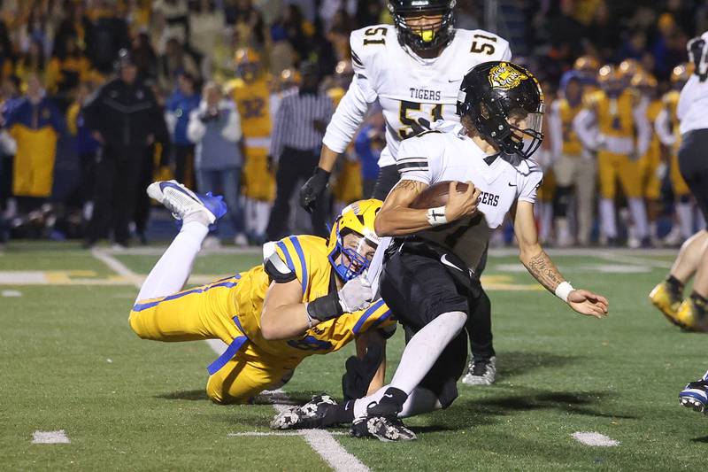 Lyons Township’s Roman Sosnovyy brings down Joliet West’s Antoine Brooks for no gain in the first round of the playoffs on Friday, Nov. 1, 2024 in La Grange.