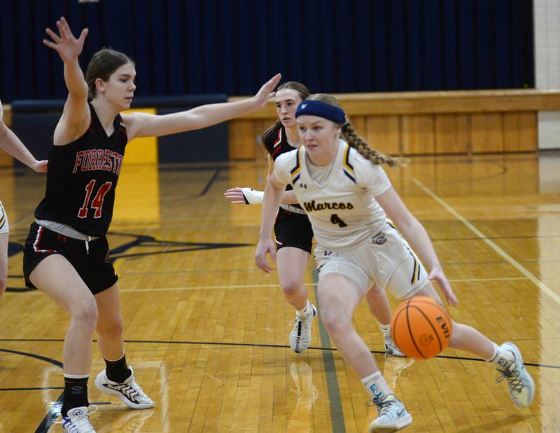 Polo's Camrynn Jones (4) drives to the basket as Forreston's Braelyn Kloster (11) defends during a Saturday, Feb. 1, 2025 game at Polo High School.