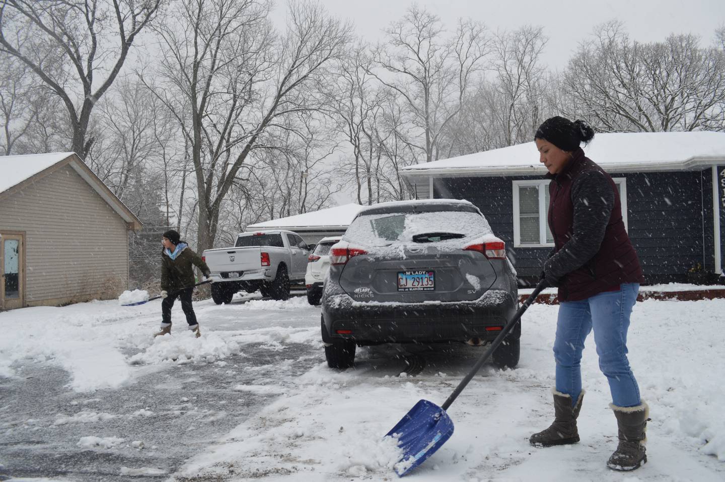 Jasmine and Heidi Mendoza shovel their McCullom Lake driveway on Tuesday, Dec. 28, 2021, the new National Weather Service record for the latest measurable snowfall in Northern Illinois.