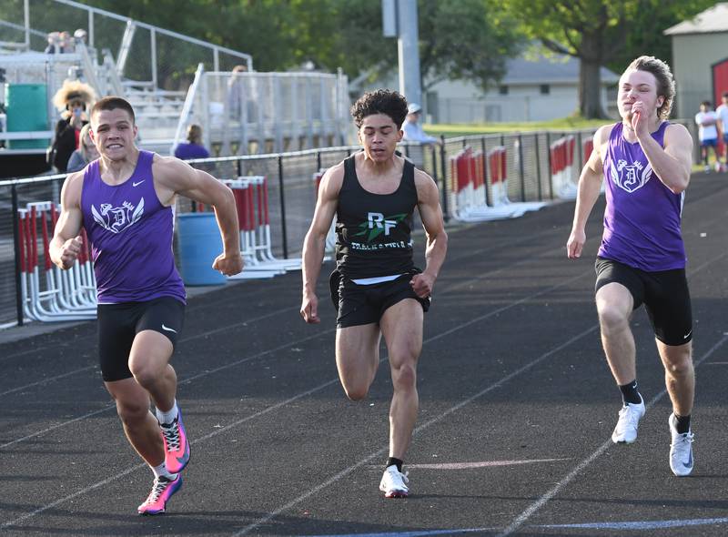 Dixon's Owen Belzer (left) checks the clock as he crosses the line first ahead of  Rock Falls' Alexavier Oquendo (center) and Dixon's Adam Staples (right) in the finals of the 100 meters at the Big Northern Conference Meet at Stillman Valley on Thursday, May 14, 2026.