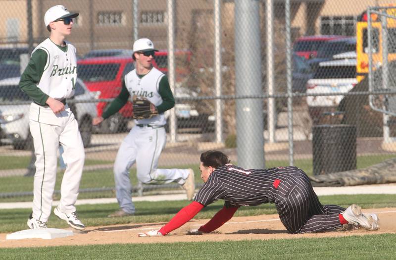 Hall's Geno Ferrari slides in safely to third base as St. Bede's Alec Tomsha waits for the late throw on Monday, March 31, 2025 at Schweickert Stadium in Peru.