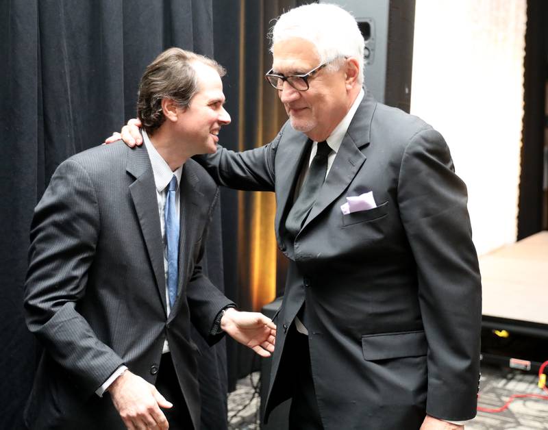 Former St. Charles Mayor Ray Rogina (right) greets his son, Matthew, after being announced as the 2022 Charlemagne Award winner during the 100th Annual Charlemagne Gala at the Q Center in St. Charles on Friday, May 13, 2022.