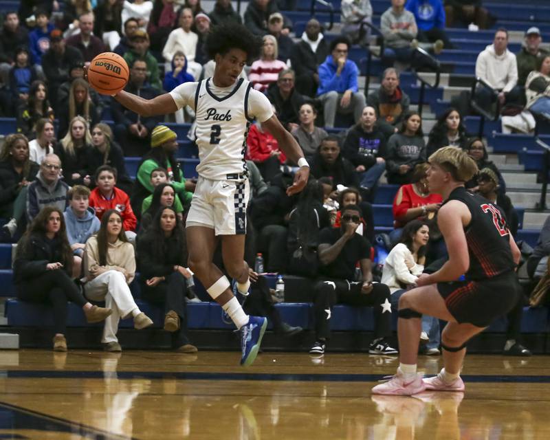 Oswego East's Jacsen Tucker (2) jumps to save a ball from going out of bounds during their basketball game between Yorkville at Oswego East. Friday, Dec 19, 2025 in Oswego.