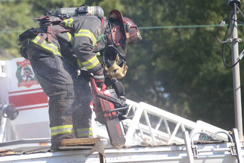 Firefighters work the scene in the back of Grassers Heating and Plumbing on Wednesday, Sept. 17, 2025 in McNabb. The fire began shortly before 10a.m. A Mutual Aid Box Alarm System (MABAS) was elevated to the fourth-alarm. No one was injured in the fire. Fire departments from McNabb, Peru, Utica, Henry, Ladd, Hennepin, Granville, Oglesby, Spring Valley, Leonore, Troy Grove, Seatonville, Wenona, Standard, Lacon-Sparland, Bureau and Tonica all responded to the scene. Firefighters left the scene at 11:30a.m.