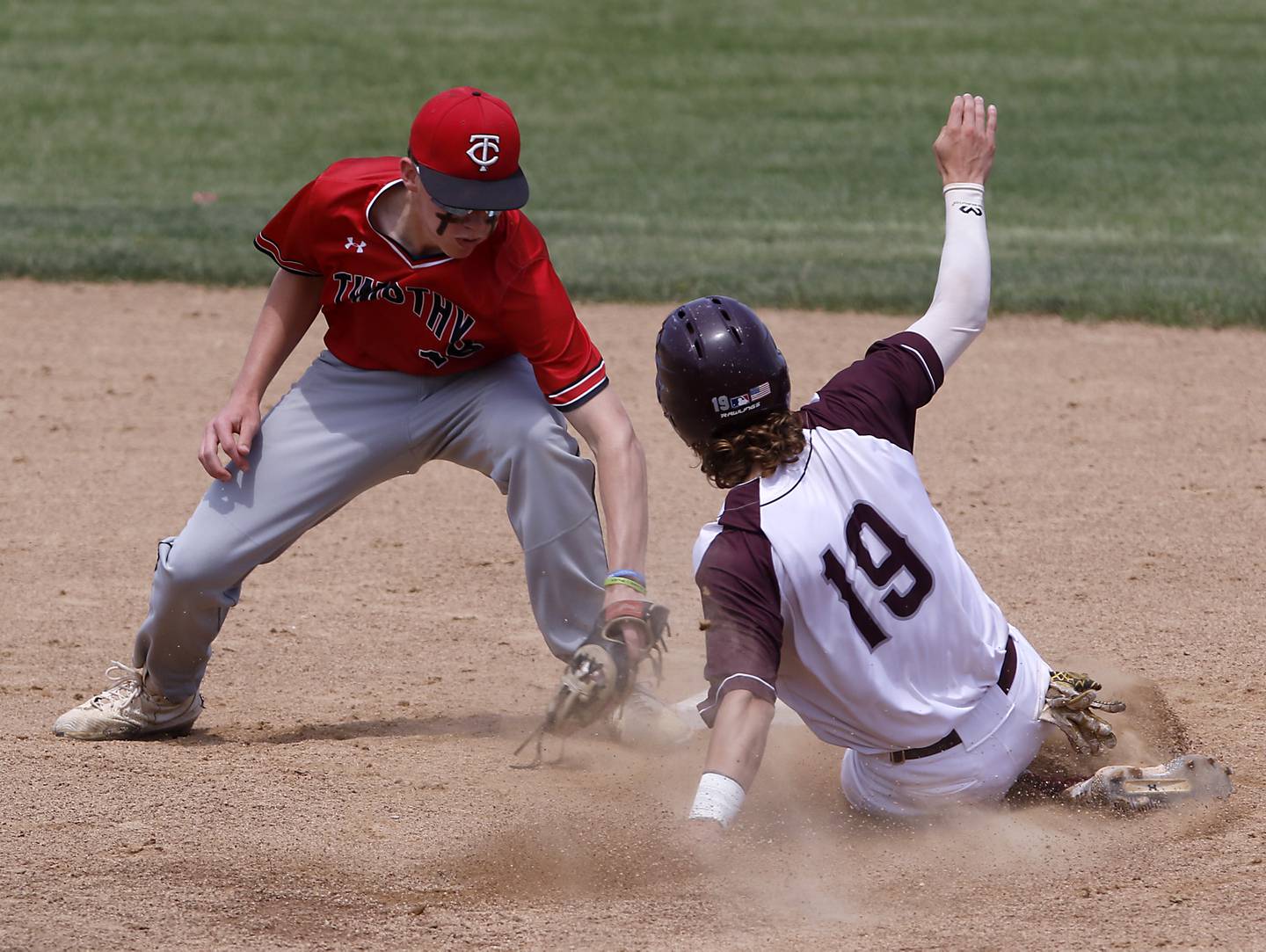 Timothy Christian’s Fletcher Roemmich tags out Richmond-Burton’s Joseph Mrowiec at second base during a IHSA Class 2A supersectional baseball game between Richmond-Burton and Timothy Christian at the Rockford Rivets Stadium in Rockford.