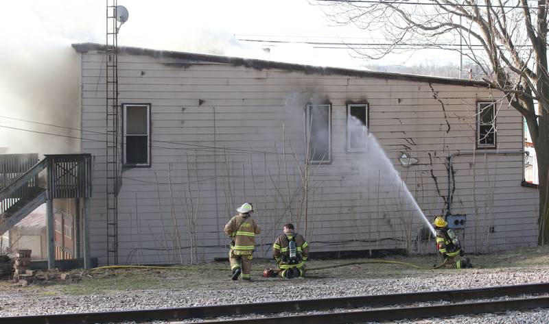 Firefighters spray water on the north side of a structure fire at the former Platform 31 tavern on Monday, March 24, 2025 on Water Street in Peru. The fire was upgraded to a three-alarm summing ire departments from La Salle, Utica, Mendota, Tonica, Ottawa, Ladd, Spring Valley, Lostant, Cedar Point, Troy Grove and Peru responded to the fire.