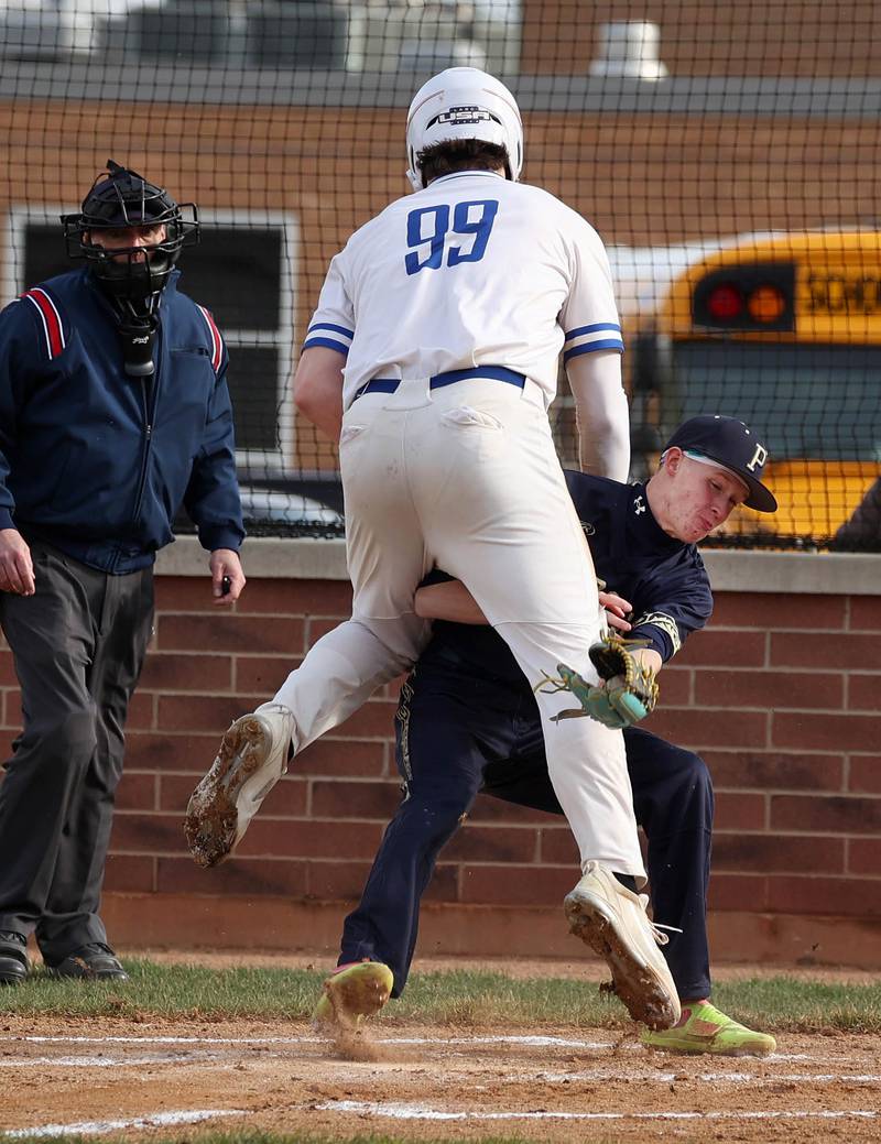 Hinckley-Big Rock’s Martin Ledbetter collides with Polo’s Jackson Willis as he crosses the plate scoring on a wild pitch during their game Thursday, April 3, 2025, at Hinckley-Big Rock High School.