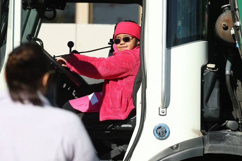 Aliani Morales, 6, sits in the Waste Management truck at the Joliet Police Department Trunk-Or-Treat event on Saturday, Oct. 26, 2024 in Joliet.