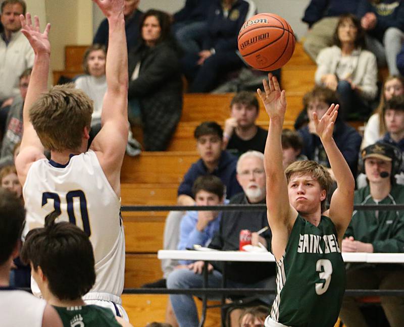 St. Bede's Callan Hueneburg shoots a jump shot over Marquette's Logan Nelson in the Class 1A Regional semifinal on Wednesday, Feb. 22, 2023 at Midland High School.
