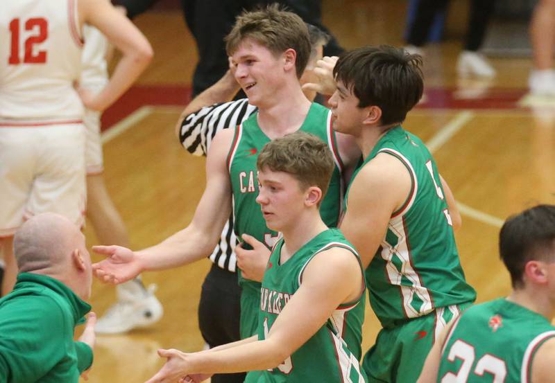 L-P's Braylin Bond, Erick Sotelol and Kyle Spelich smile while going to the bench during a time out against Ottawa on Friday, Feb. 6, 2026 in Kingman Gymnasium at Ottawa High School.