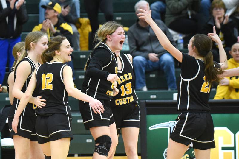 Reed-Custer's Harlie Liebermann, center, and her Comet teammates celebrate after upsetting top-ranked Coal City 48-33 in the IHSA Class 2A Coal City Regional semifinals Tuesday, Feb. 18, 2025.