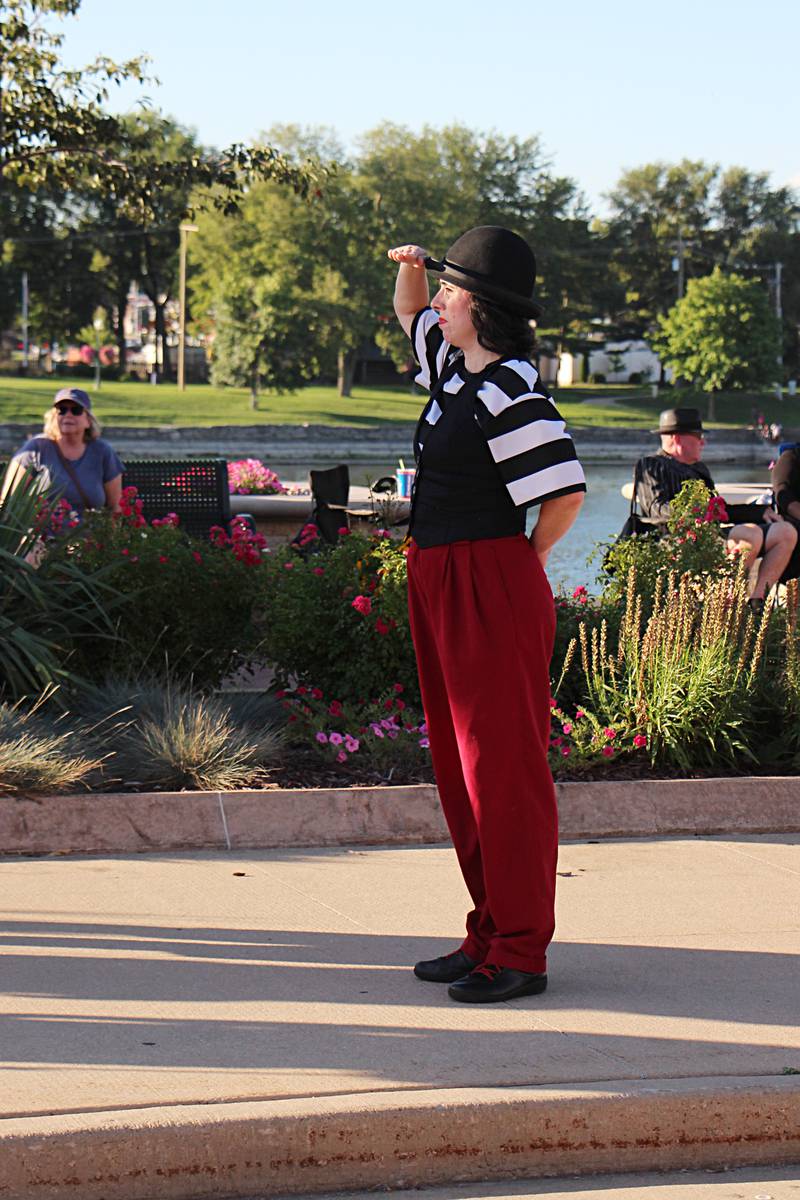 A performer dressed as a mime from Matthew McMunn Entertainment looks onto the crowd Saturday, August 12, 203 during Venetian Night in Dixon.