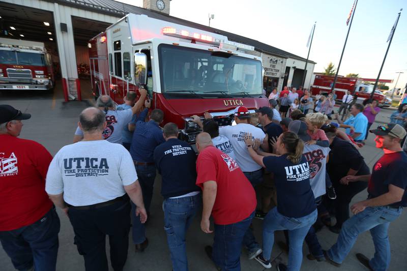 Utica firefighters, push in a new Pierce Heavy Duty Rescue Truck at the Utica Fire Station on Thursday, Sept. 14, 2023. It's a tradition for the Utica Fire Department to push in a new fire truck into the bay. The $706,000.00 truck will replace a 28 year old rescue truck. The new vehicle will have equipment to handle water rescue, industrial accidents and grain bin emergencies. The department hopes to have it in operation on Columbus Day weekend.