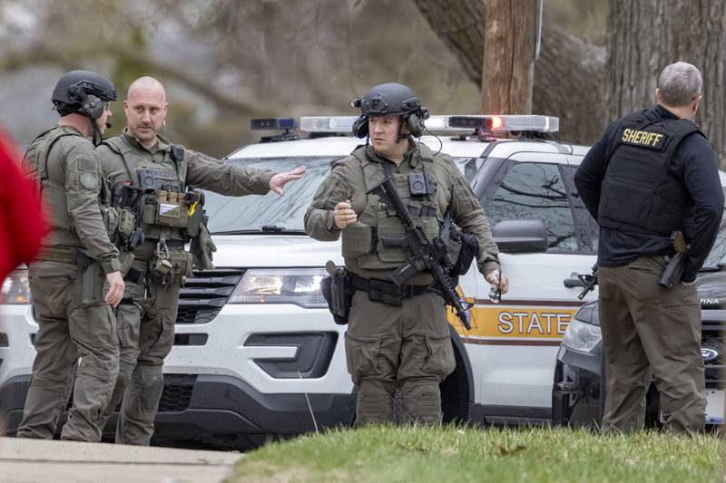 Police officers discuss the situation that occured at a two-story apartment building on the corner of Seventh and Charters on Sunday, March 30, 2025 in La Salle. A barricaded armed subject fired shots at officers. Police from across the Illinois Valley assisted in the incident.