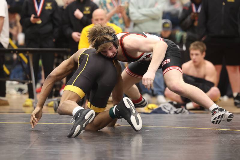 Yorkville’s Jack Ferguson spins around Joliet West’s Aiden Brown in the 157-pound weight SPC Conference championship match at Joliet West on Saturday, Jan 25, 2025.