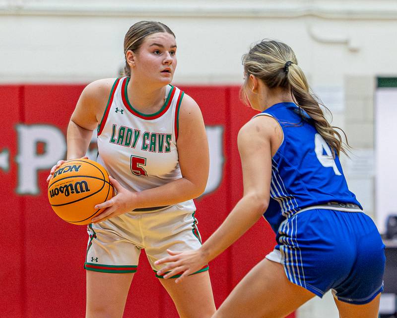L-P's Emma Jereb (5) holds ball in triple treat as Madie Gibson (4) of Princeton defends on Saturday, Feb. 7, 2026 in Sellett Gymnasium at L-P High School.