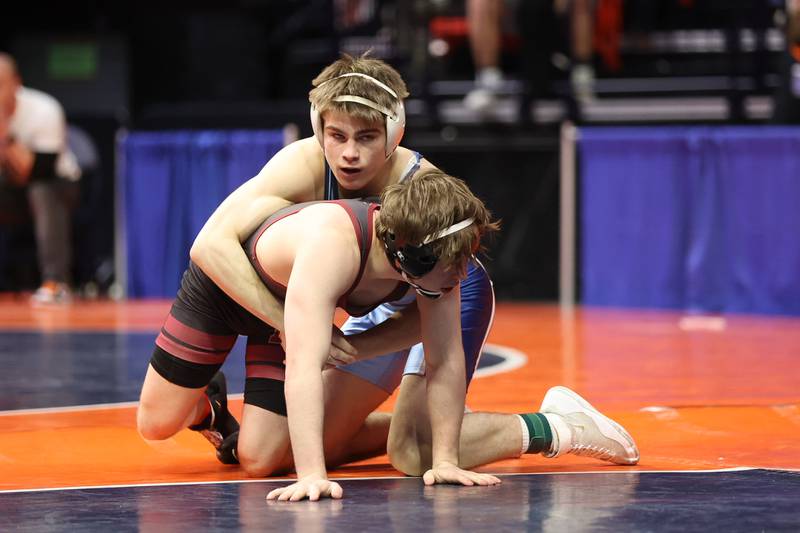 Downers Grove South’s Jimmy Nugent works over Moline’s Kole Brower in the Class 3A 138lb. semifinals at State Farm Center in Champaign. Friday, Feb. 18, 2022, in Champaign.