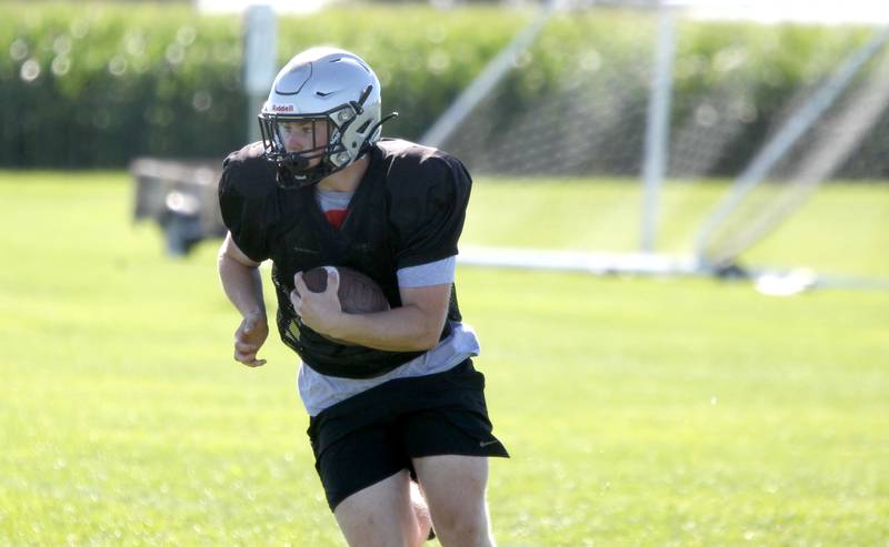 Kaneland’s Tyler Bradshaw runs the ball during practice in Maple Park on Wednesday, Aug. 10, 2022.
