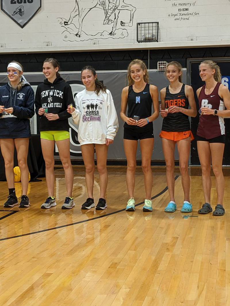 From left: Cary-Grove's Ada Saletnik (sixth), Fenwick's Bella Daley (fifth), Crystal Lake South's Bella Gonzalez (fourth), Nazareth's Colette Kinsella (third), Crystal Lake Central's Hadley Ferrero (second) and Prairie Ridge's Rachel Soukup (first) in the Class 2A Kaneland Cross Country Sectional.