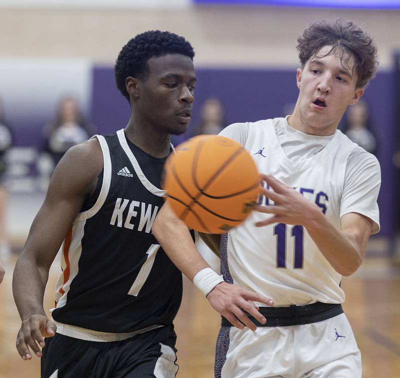 Dixon’s Brody Nicklaus dishes off a pass against Kewanee’s Dayvon Robinson Tuesday, Dec. 2, 2025.