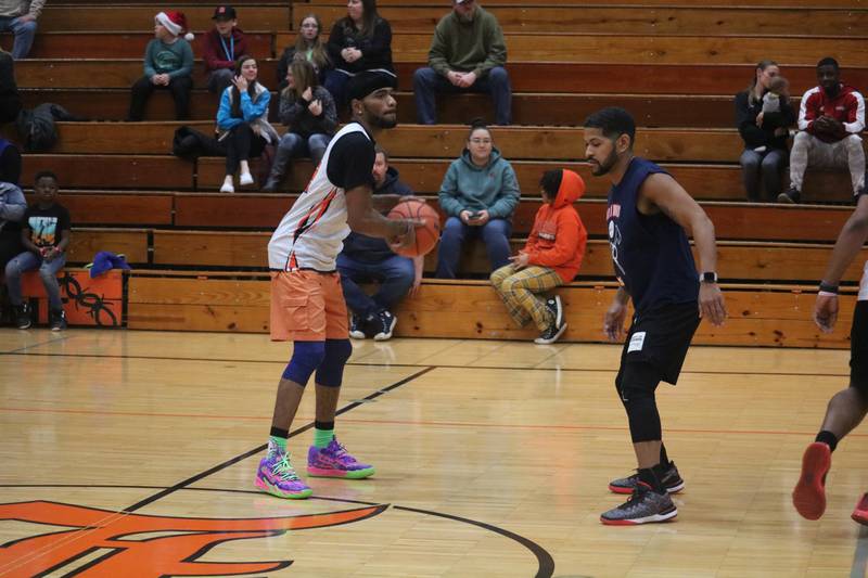 Xavier Johnson (left) looks to pass the ball while being defended by Ray Hernandez Dec. 4, 2023 during the Guns and Hoses Basketball Game put on at Huntley Middle School in DeKalb.