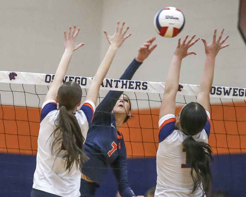 Oswego's Hannah Herrick (7) hits the ball for a kill during volleyball match between Romeoville at Oswego. Oct 16, 2025.