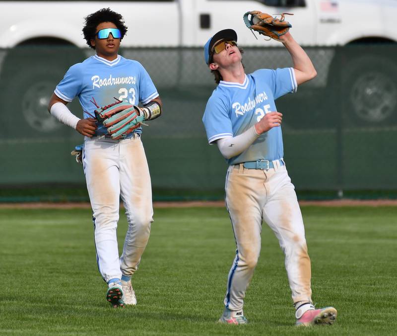 Nazareth's Landon Thome (25) catches a popup in shallow right field as right fielder Kamran Alikhan (23) back him up during a game on April 22, 2024 at Benet Academy in Lisle.