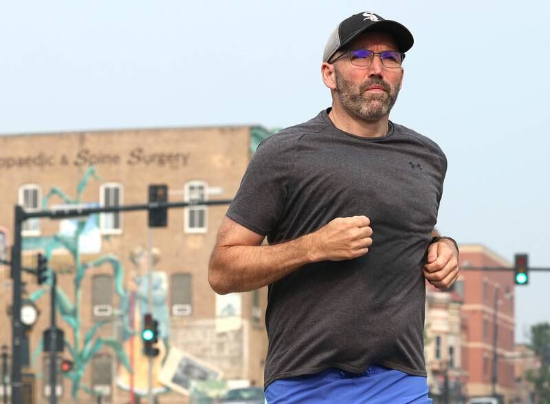 Shawn Beck, from DeKalb, runs west Wednesday, June 28, 2023, on Lincoln Highway just west of First Street in DeKalb. Beck recently completed his goal of running every street in DeKalb County.