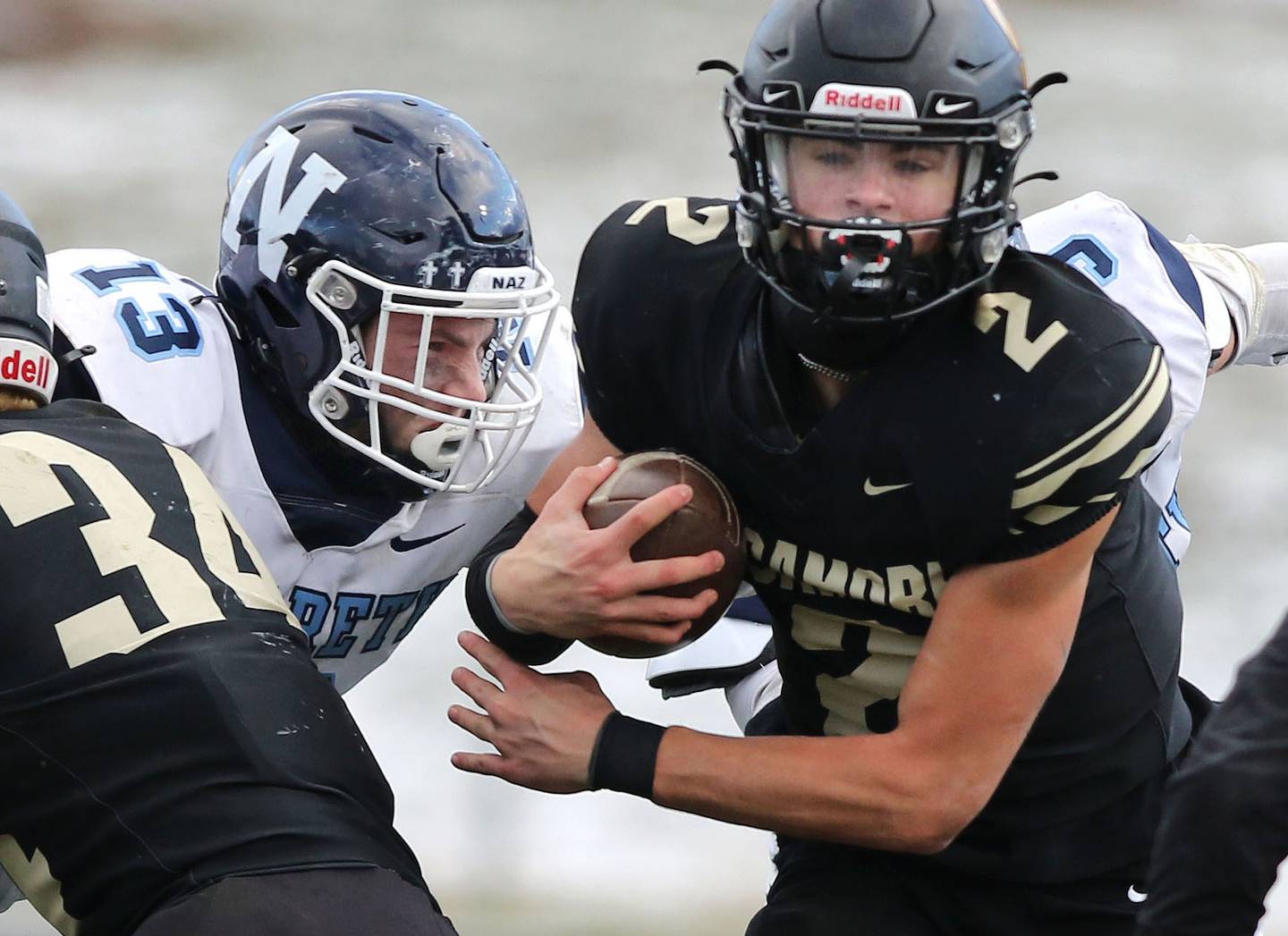 Nazareth's Brady Gorman hits Sycamore's Elijah Meier Saturday, Nov. 18, 2022, during the state semifinal game at Sycamore High School.