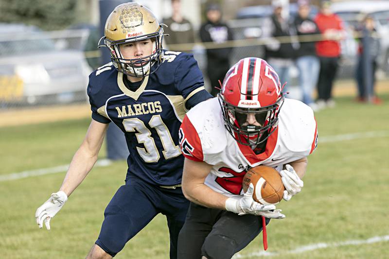 Amboy’s Brayden Klein intercepts a pass in front of Polo’s Noah Dewey Saturday, Nov. 11, 2023 during a semifinal 8-man football game in Polo.