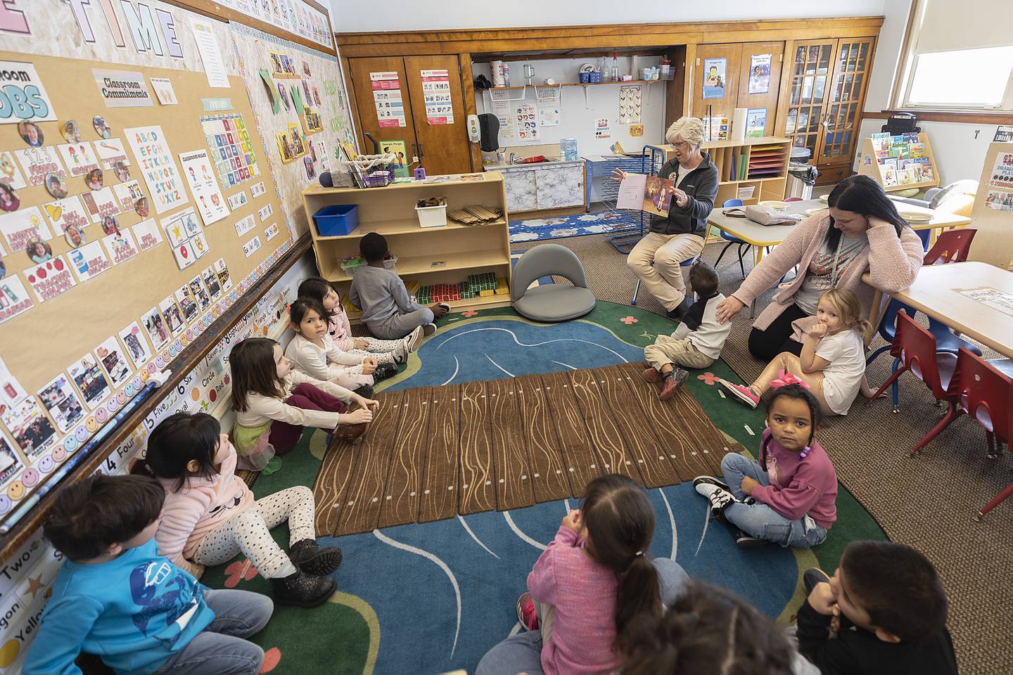 Stacy Flanagan, Chief of Staff for State Rep. Brad Fritts, reads a book Thursday, Jan. 23, 2025, to students in the Wallace School TCOC Head Start program in Sterling.
