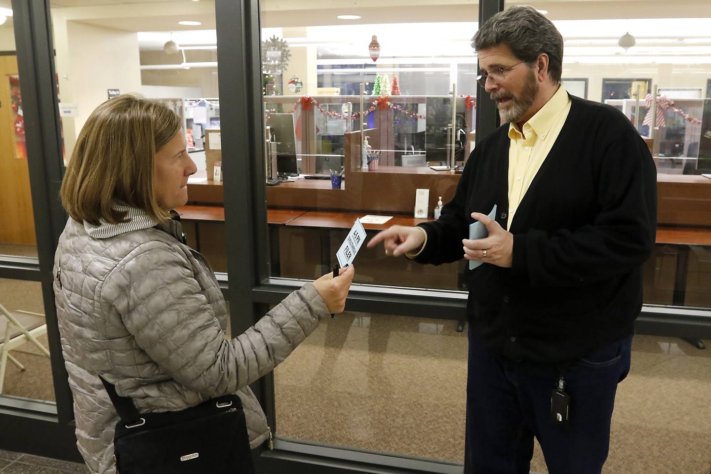 McHenry Count Clerk Joe Tirio talks with Anne Boone, who is running for Algonquin Township district 57 before she files her candidate forms on Monday, Dec. 4, 2023, at the McHenry County Clerk's Office in Woodstock. Monday was the last day for candidates to file ahead of the March primaries.